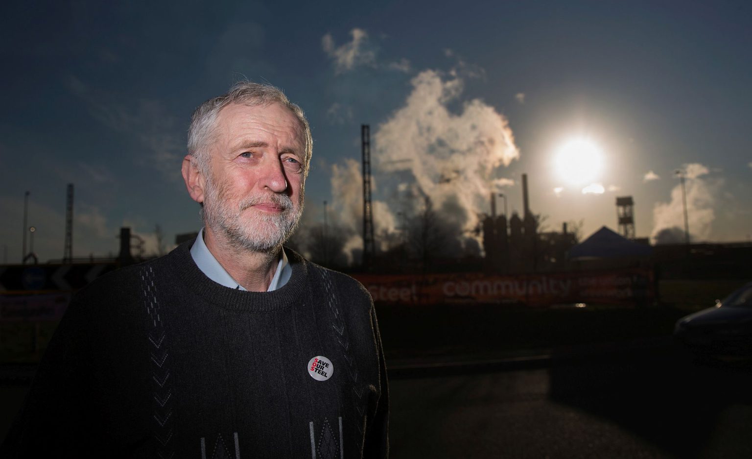 Corbyn poses for the media outside the Tata Steel plant on 30 March, 2016, in Port Talbot, Wales