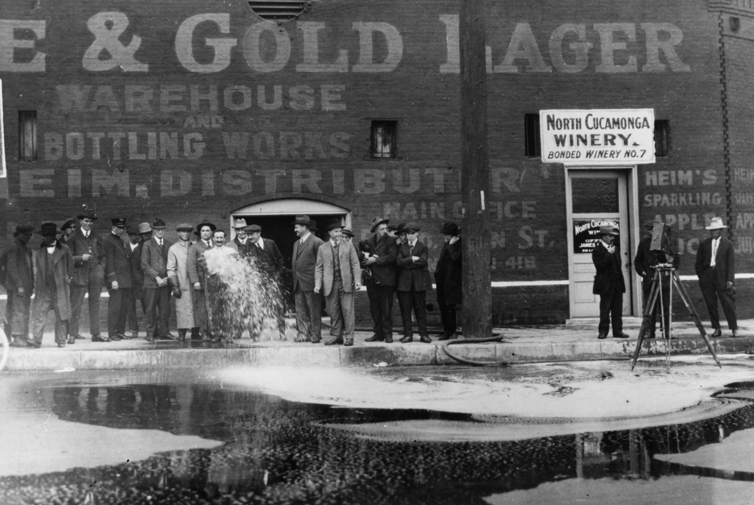 33,100 gallons of wine being flushed into the gutter outside the North Cucamonga Winery in Los Angeles, February 1920 (Getty).