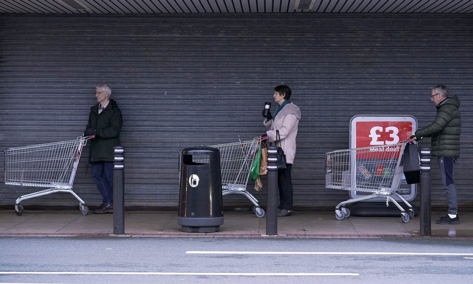 People queue to shop at Sainsbury's supermarket on 19 March 2020 in Northwich, UK.