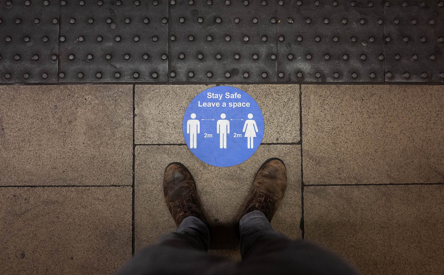 A social-distancing sticker on a London underground station platform, 11 May 2020.