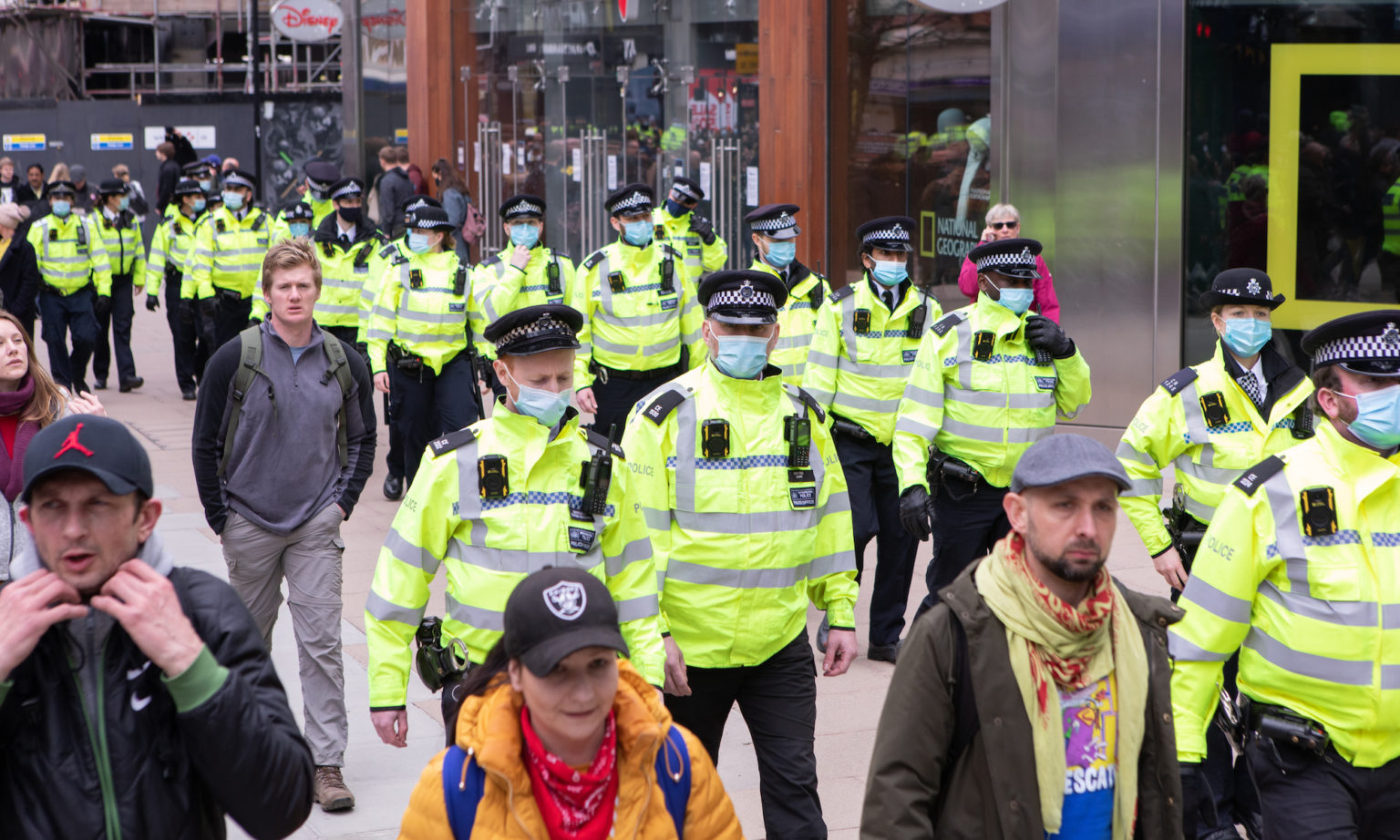 Officers follow the demonstrators down Oxford Street.