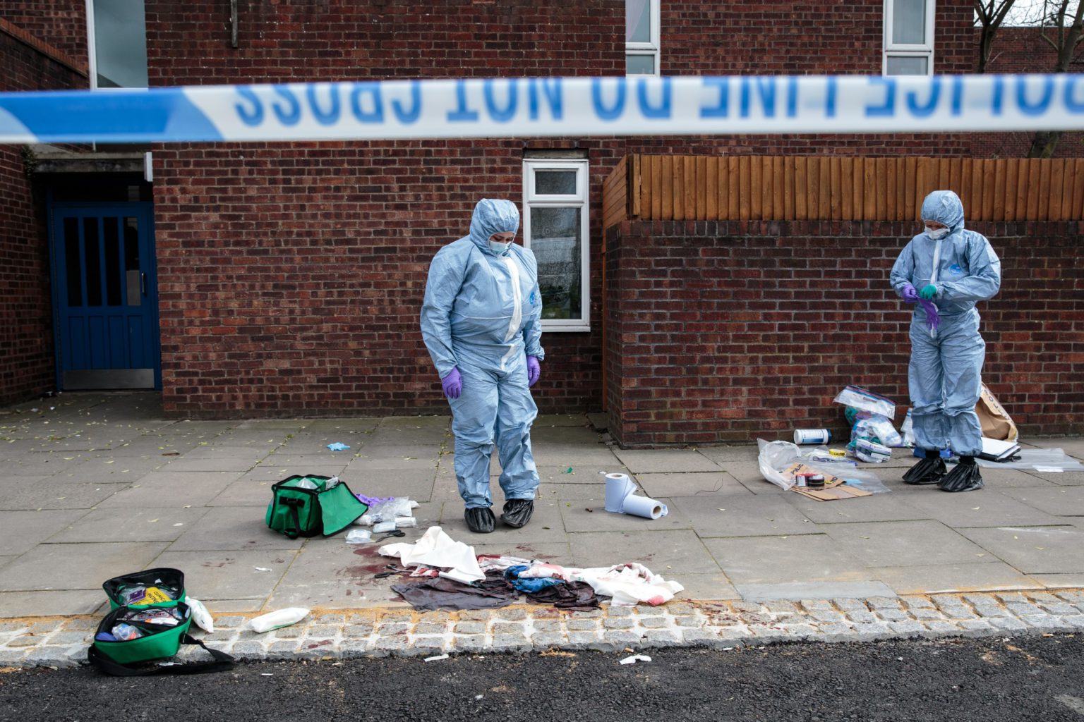 Forensics teams work at the scene of a stabbing in Edmonton, 31 March 2019.