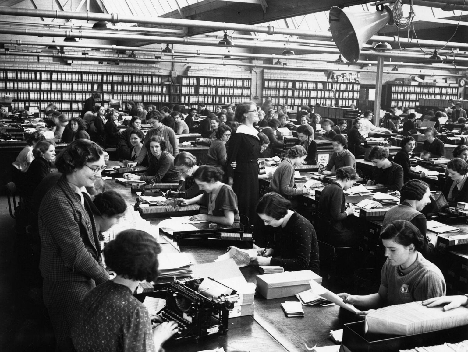 Female office workers in an open-plan office, circa 1935.