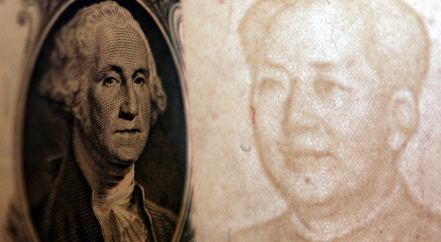 Details of dollar and a yuan notes are seen at a bank on 15 May 2006, Beijing, China.