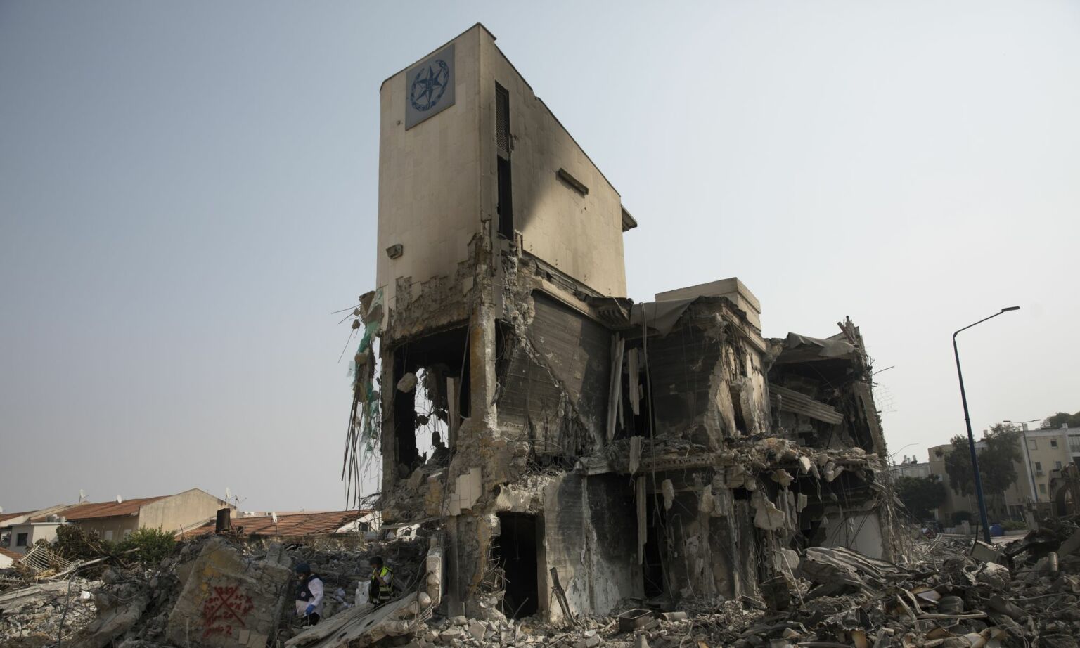 Israeli rescue workers at Sderot police station after it was destroyed in a battle between Israeli troops and Hamas militants, 8 October 2023.