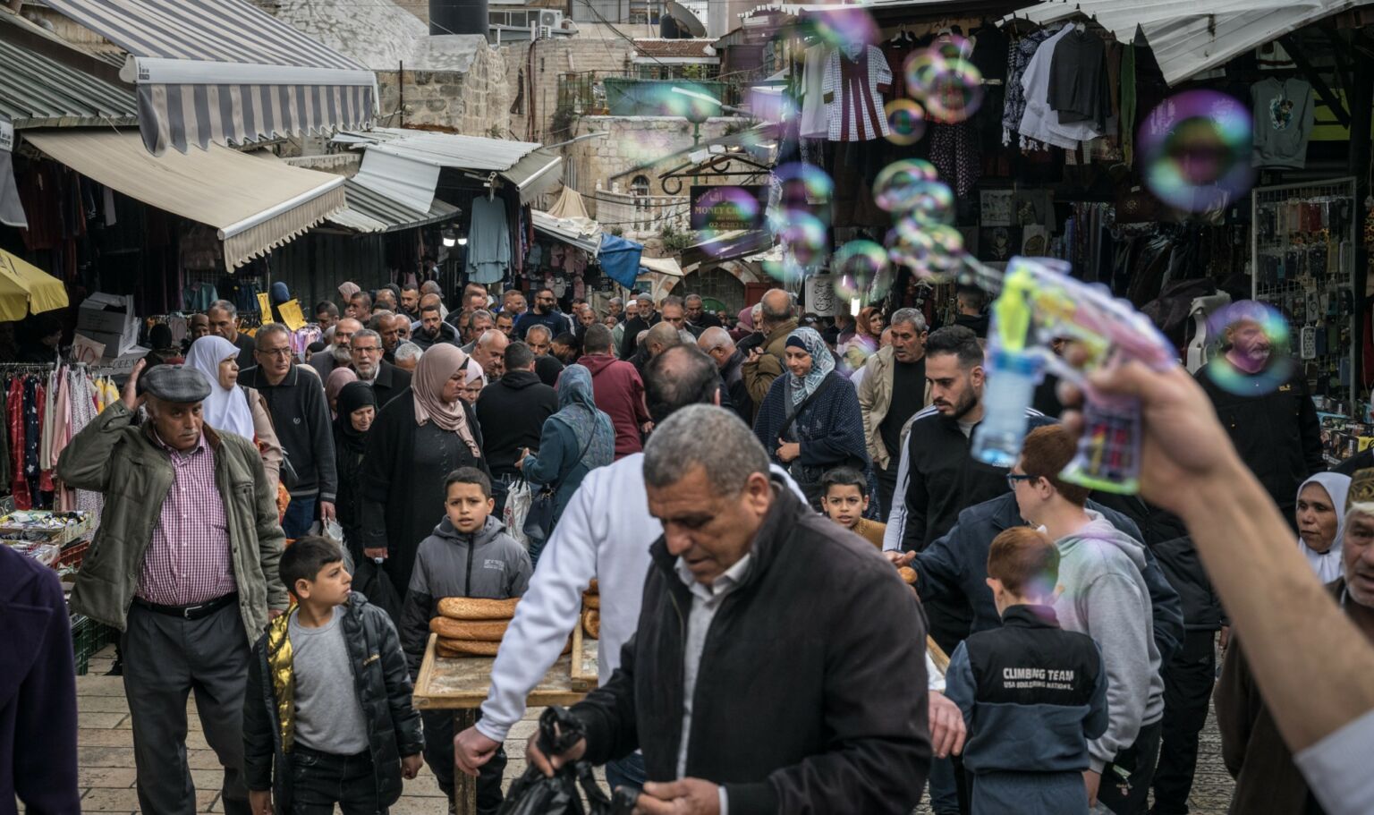 People walk in the Old City, in Jerusalem, after the first Friday prayers of Ramadan, 15 March 2024.