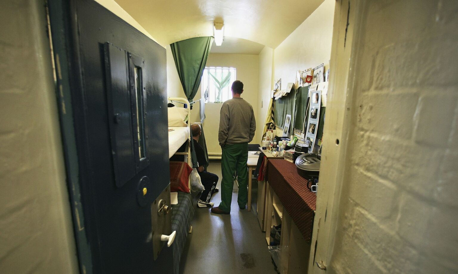 Prisoners look towards a window in a cell in A Wing of Norwich Prison.