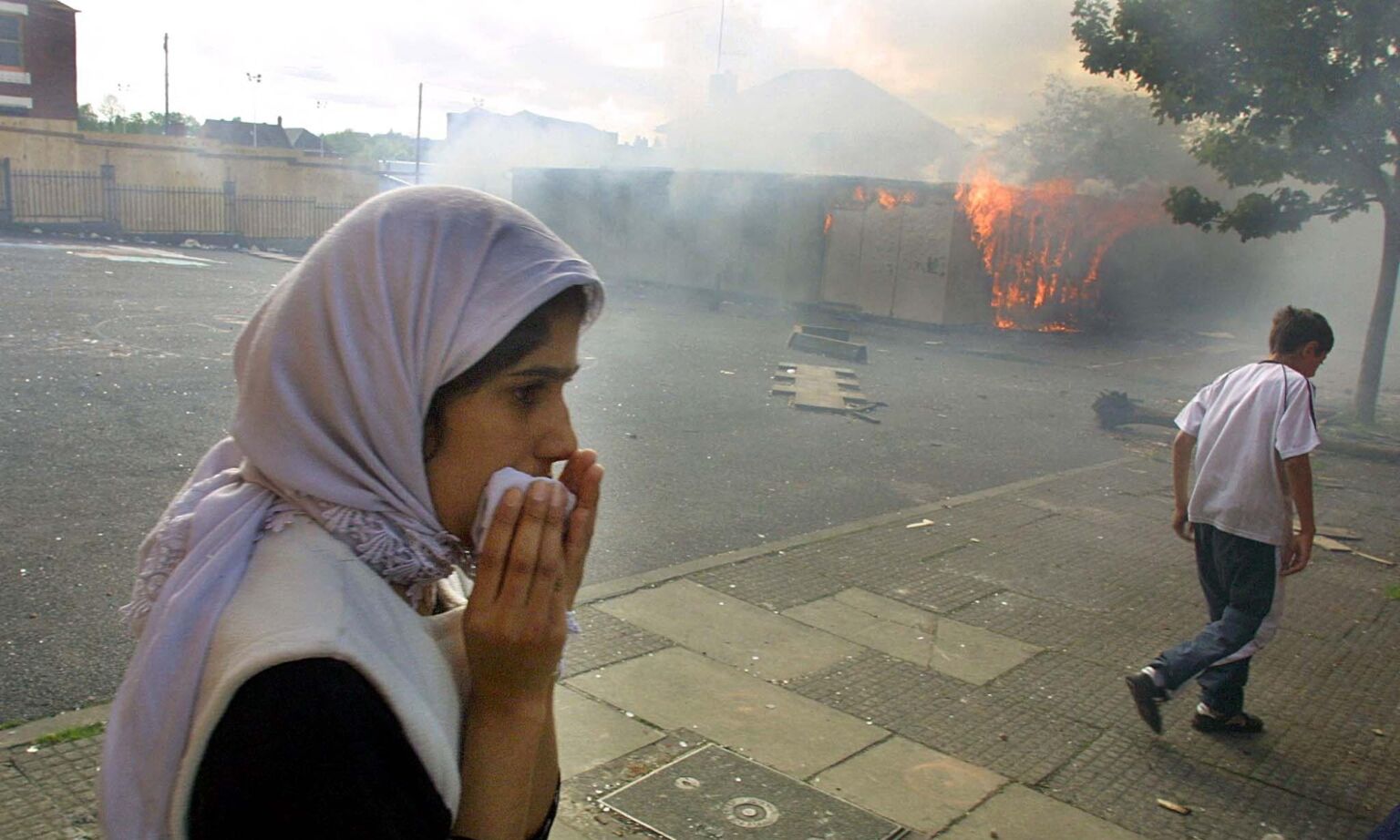 Greenhill Mill school on fire after being petrol-bombed during riots in Oldham, 28 May 2001.