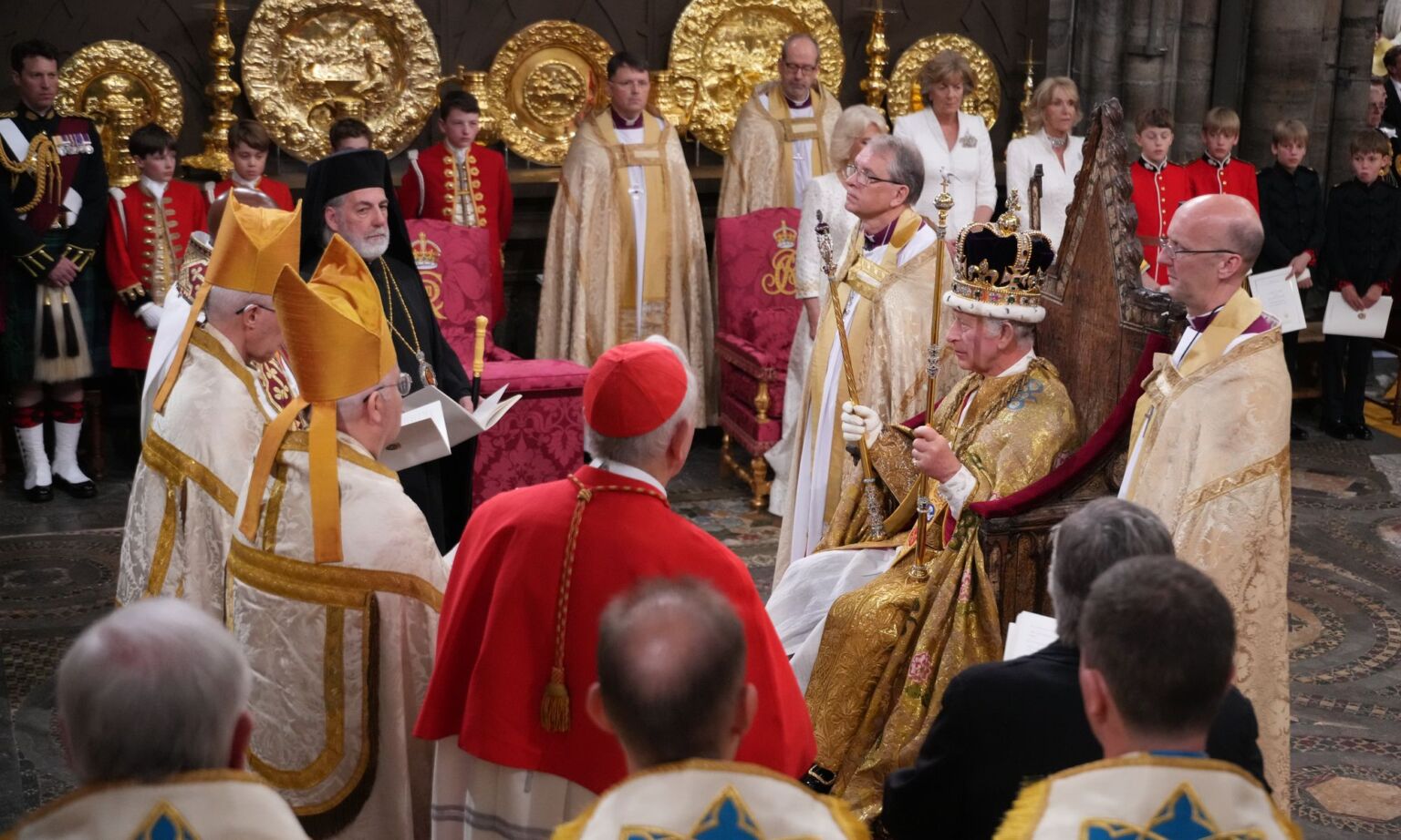 King Charles III is crowned surrounded by faith leaders during his coronation ceremony in 2023 in London, England.
