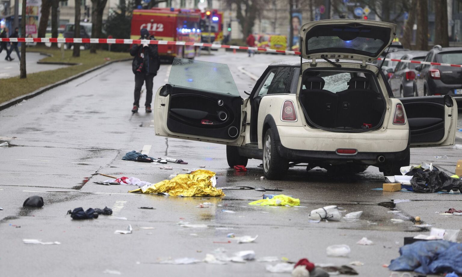 Police and emergency services operate near a car that drove into demonstrators in Munich on 13 February 2025.