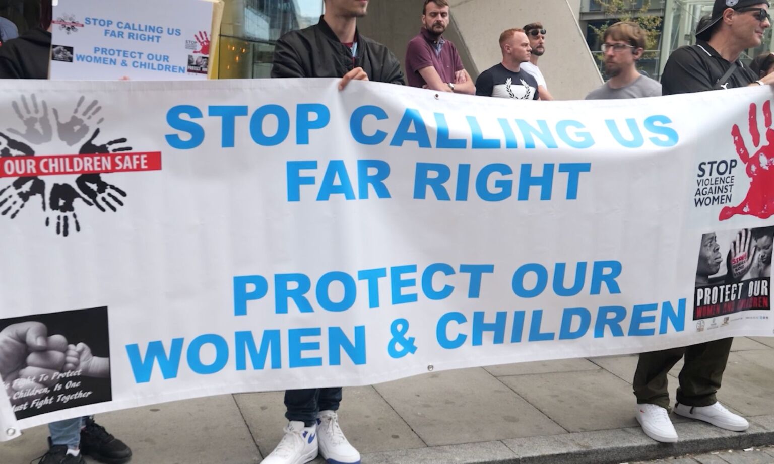 Protesters hold up a banner at the Britannia International Hotel demonstration.