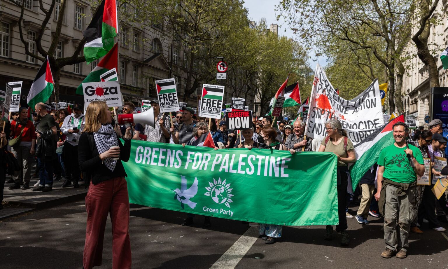 Green Party activists take part in a March for Palestine in London, 13 April 2024.