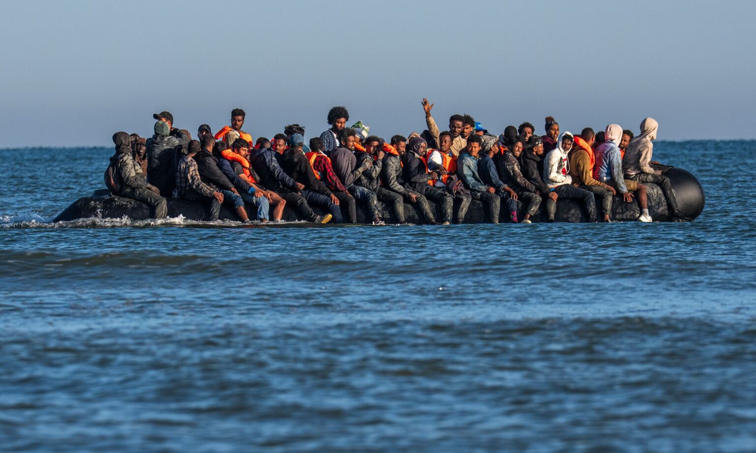 Migrants on a dinghy as they prepare to cross the English Channel on 25 August 2025 in Gravelines, France. 