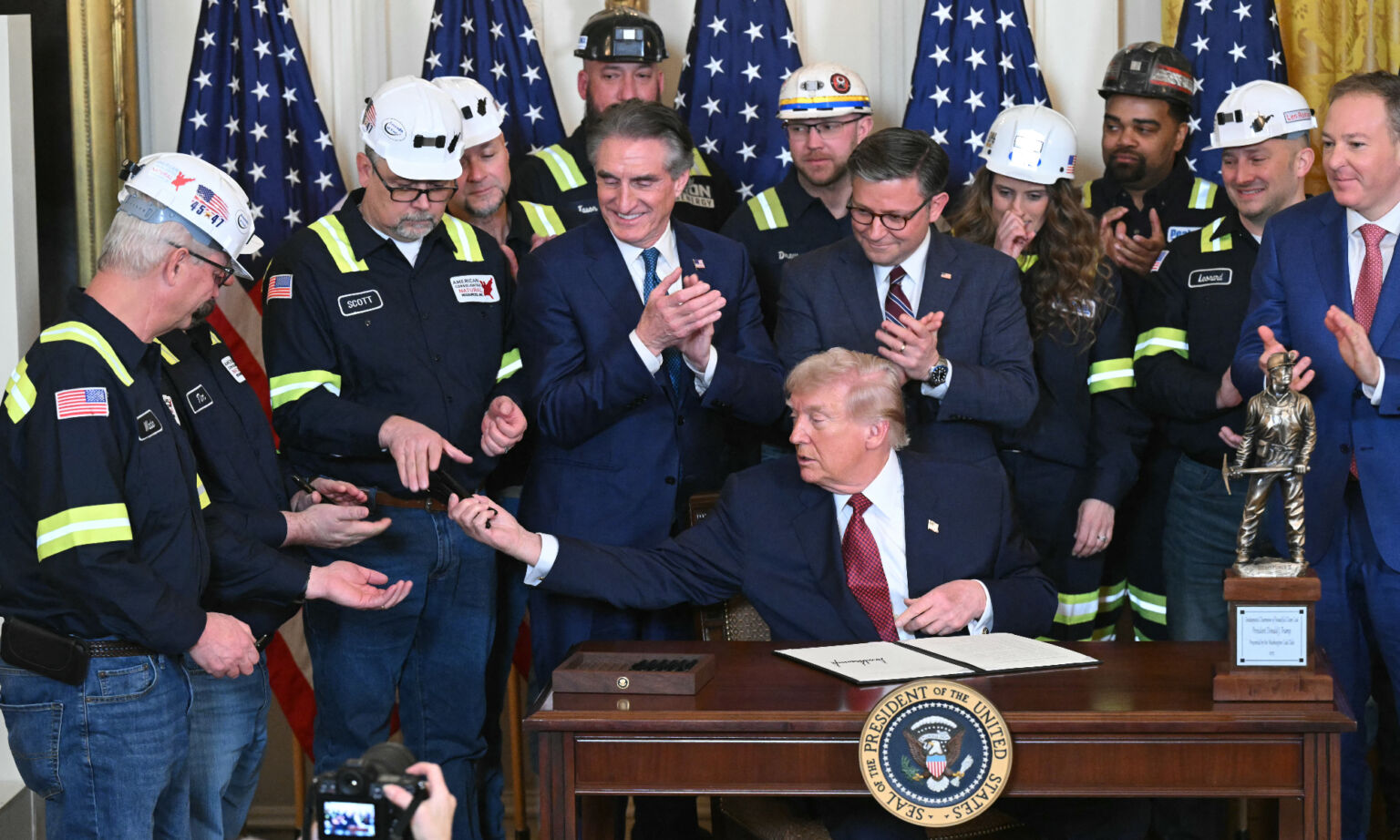US president Donald Trump with coal miners at the White House in Washington, DC, 11 February 2026.
