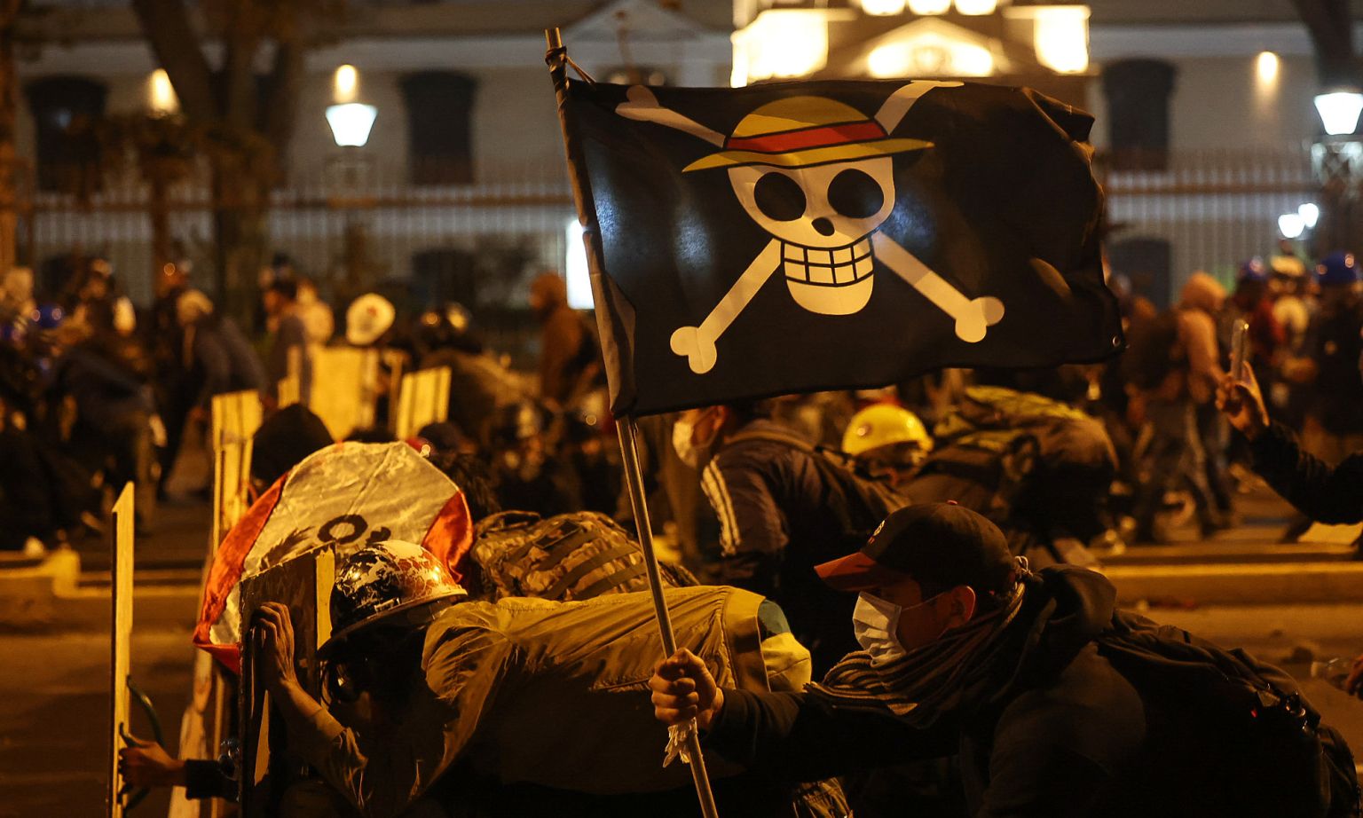 Protesters hold up a One Piece pirate flag during clash with anti-riot police in Lima, Peru, 15 October 2025.