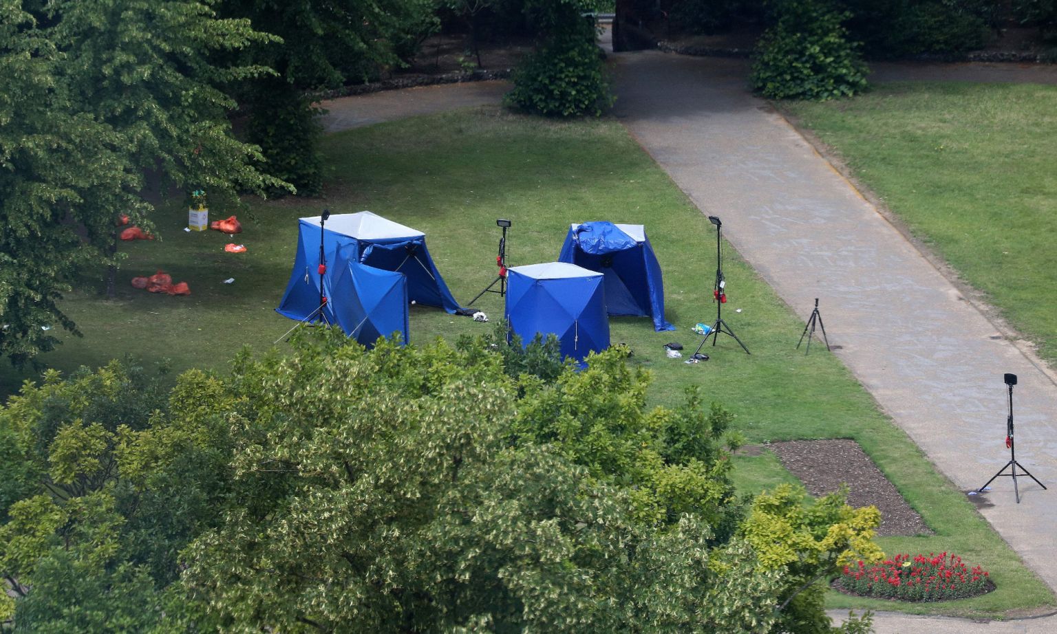 Police tents and equipment at a fatal stabbing in Forbury Gardens park, Reading, 21 June 2020.